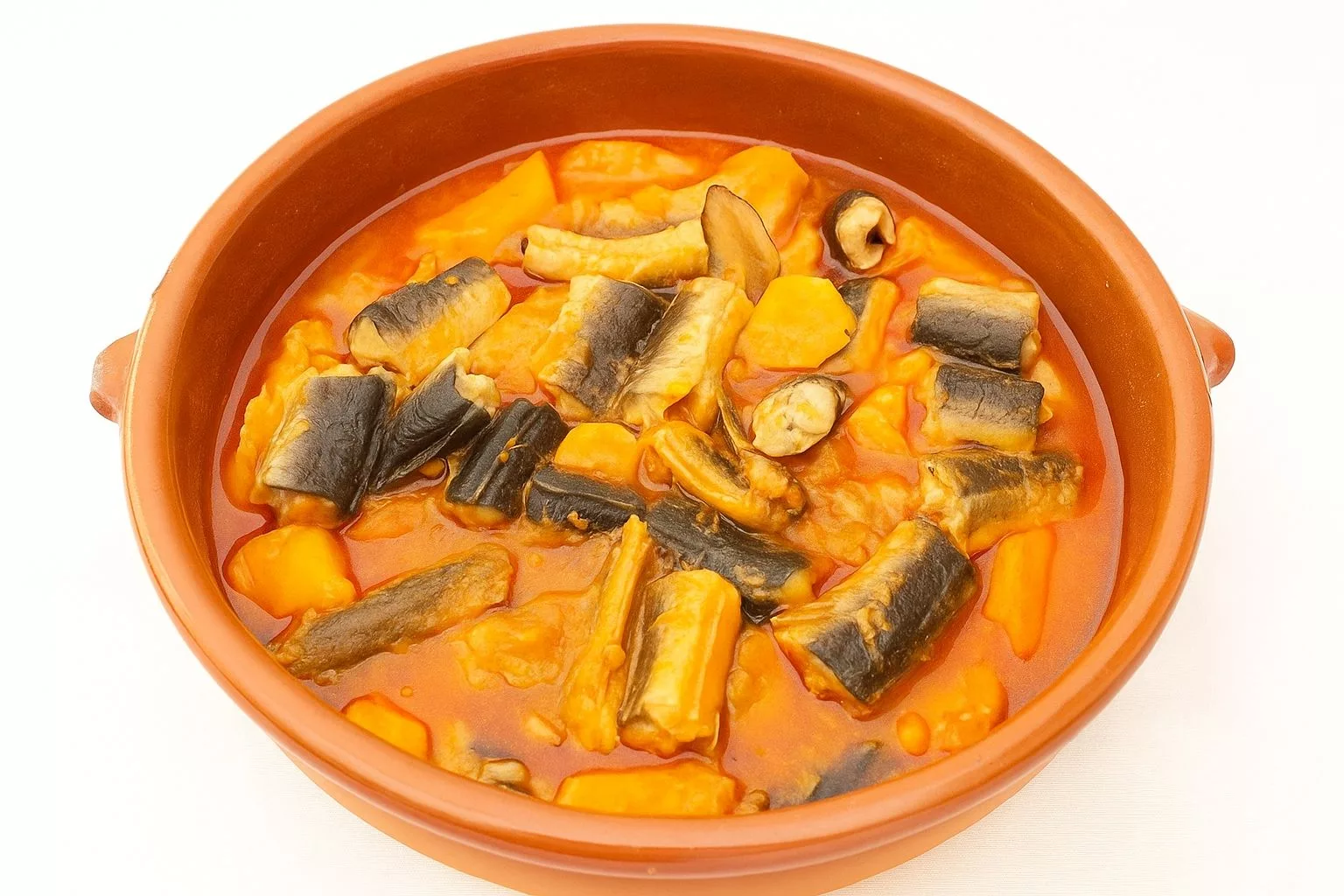 Plato de all i pebre con anguila servido en cazuela de barro
